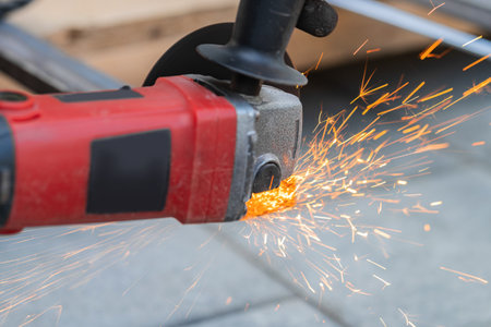 working with a circular saw cutting metal close-upの写真素材