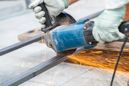 working with a circular saw cutting metal close-up