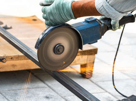 working with a circular saw cutting metal close-upの写真素材