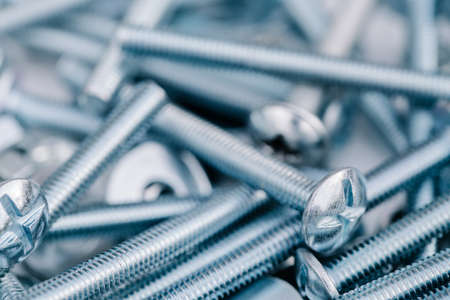 background of new bolts and nuts close-upの写真素材