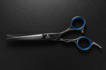 Close-up of hairdressing scissors on a black background