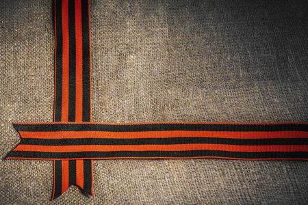 Military cap with order of Great Patriotic war and tulips flowers tied by Saint George ribbonの写真素材