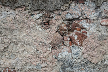 Rock texture and surface background. Cracked and weathered natural stone background. The wall of the ruined houseの写真素材