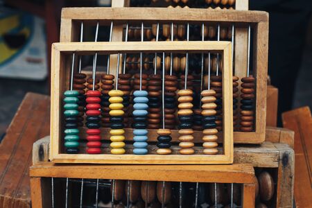 Old wooden abacus on abacus backgroundの写真素材