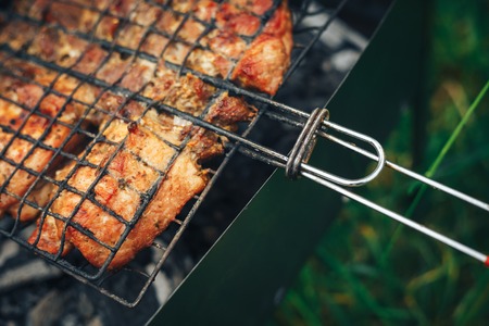 Barbecue skewers meat kebabs on flaming grillの写真素材
