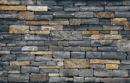 Stone wall, brick rock texture, stone texture. Different color stones. Grey and warm backgroundの写真素材
