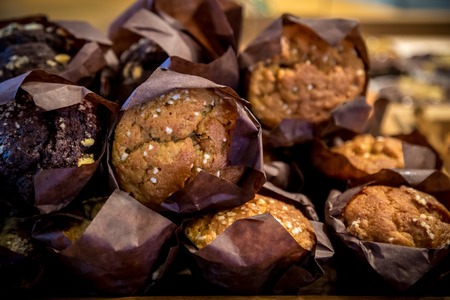 chocolate muffins in a paper wrapper with almondsの写真素材