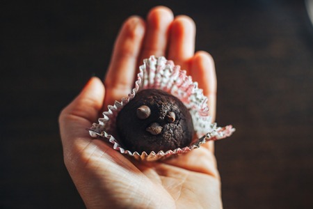 Traditional russian cake truffle potato in woman handの写真素材