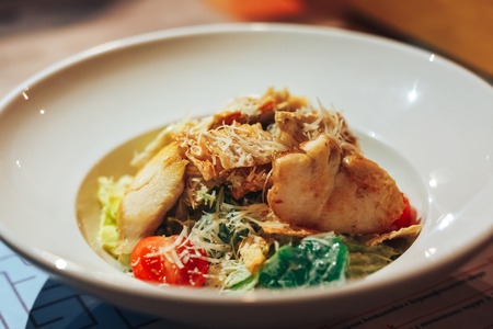 Chicken Caesar Salad. Caesar Salad with grilled chicken on plate. Grilled chicken breasts and fresh salad in plateの写真素材