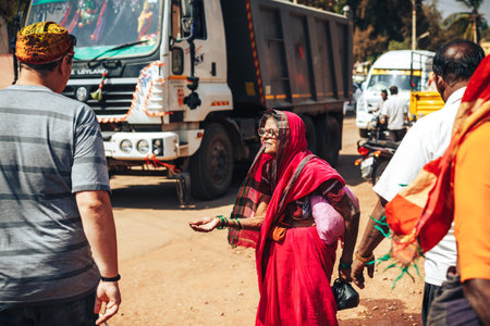 Beautiful Indian grandma in colorful cloths is standing with an outstretched handのeditorial素材