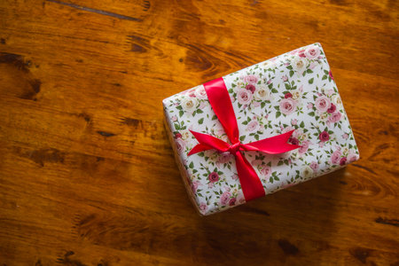 A handful of gift boxes are empty on a wooden floor. Love is a gift for someone special.