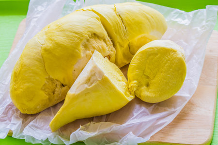 Toggle durian shell lay on a wooden cutting board.