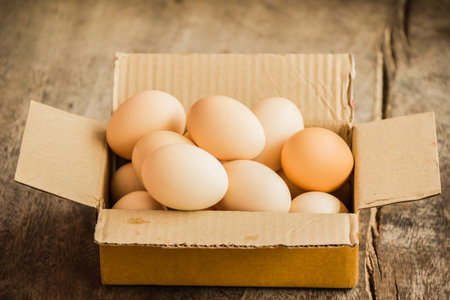 A number of eggs are in a blank box on the table.の写真素材
