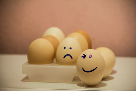 A number of eggs are filled with a pen with a facial expression.の写真素材