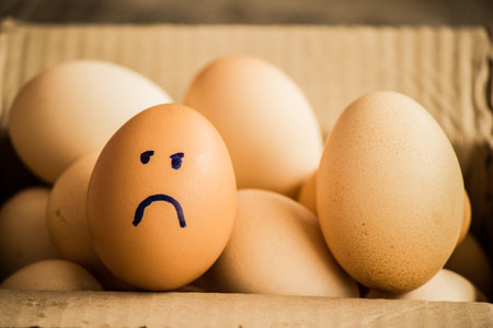 A number of eggs are filled with a pen with a facial expression.の写真素材