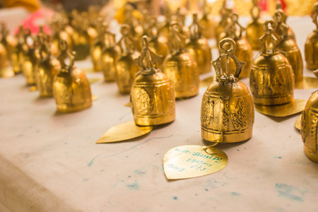 The letter on the gold plate is a letter Pho is the name of Miss Wanpen Nana's name is the name of my own writing our name on the bell is a lucky fortune and Sirimong. According to the belief of Buddhism.の写真素材