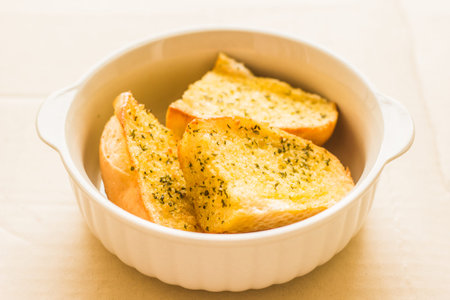Garlic bread is placed in a container