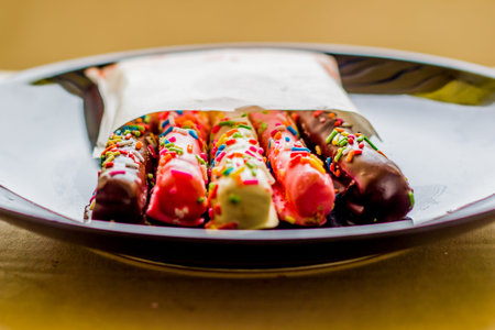 Fancy bread sticks in colorful paper bags.の写真素材
