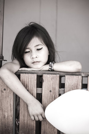 Black and white photo girl holding balloons.の写真素材