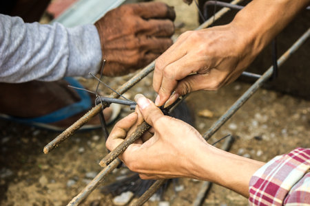 The mechanic is using a wire tied with steel.の写真素材