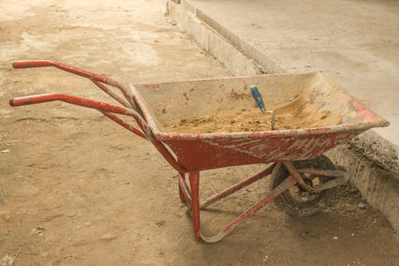 A small sand cart has a single wheel to help ease the labor of the domestic laborers.の写真素材