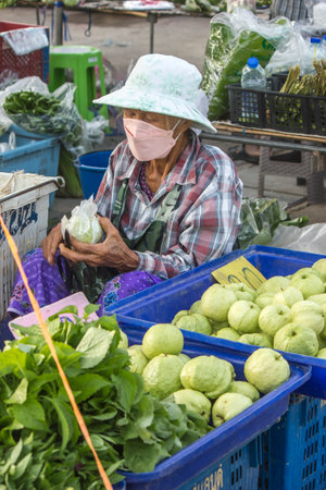 RATCHABURI, THAILAND - AUGUST 10: The epidemic of covids is severe. Sellers will wear masks to prevent infection in the market on August 10, 2021 in Ratchaburi, Thailand.のeditorial素材