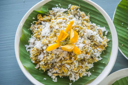 Sesbania flower is a dessert that is mixed with rice flour and then steamed. When cooked, bring the crunchy coconut, salt, sugar to mix and eat.の写真素材