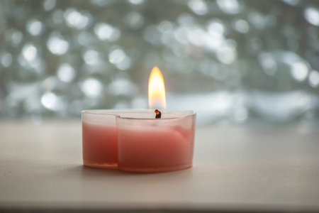 A heart-shaped pink candle is placed to emit a fragrant scent.の写真素材