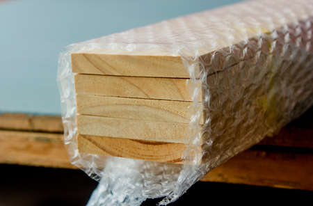 Five slats of pine are tied together and covered with cushioning panels.の写真素材