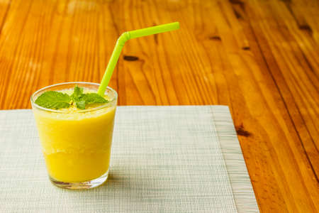 Freshly squeezed pineapple in a glass, ready to serve, leaving space for text.の写真素材