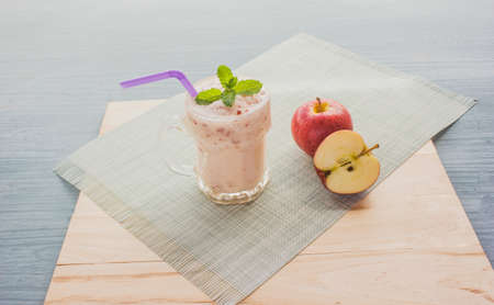 Apple smoothie with yoghurt and mint leaves and applesの写真素材