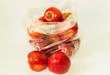 apples in transparent plastic bags on white backgroundの写真素材