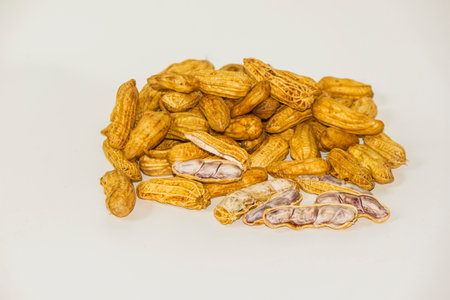 Boiled peanuts, shelled and seeds inside on a white background.の写真素材