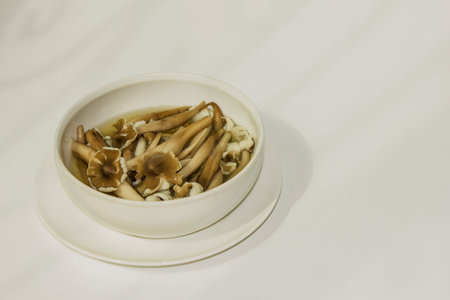 Termitomyces fuliginosus Heim, boiled mushrooms in a cup on white background.の写真素材
