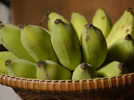 Green Bananas in Basketの写真素材
