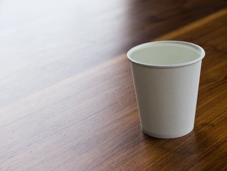 Drinking water in white paper cupの写真素材