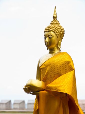 Buddha statue with alms-bowlの写真素材