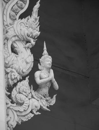 Worship of angel statue on Buddhist temple