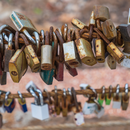 Old keys on sling of bridge, believe owner will be together foreverの写真素材