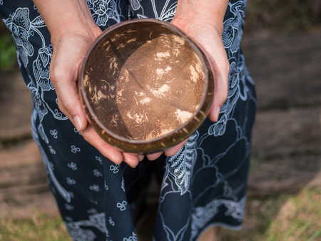 Coconut bowl on hand, concept ask for, donateの写真素材