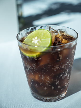 Lemon cola with ice in glassの写真素材