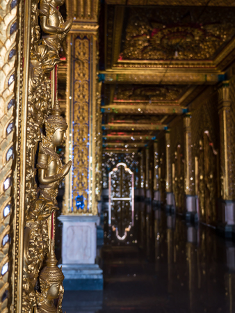 Thai angel statue on door in ancient Buddhist templeの写真素材