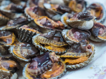 Grilled scallop, cockle, seafood mealの写真素材