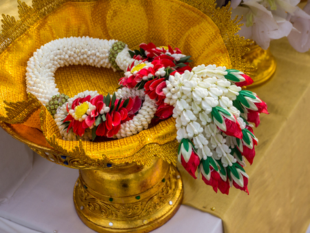 Garland or Lei of flowers on gold tray with pedestalの写真素材