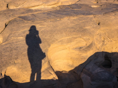 Shadow of photographer on mountain rock background