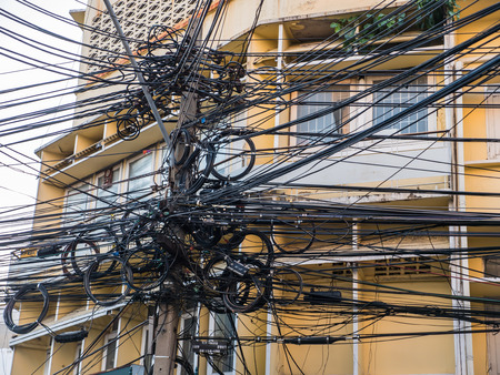 Messy cable lines on electricity power pole in Bangkok cityの写真素材