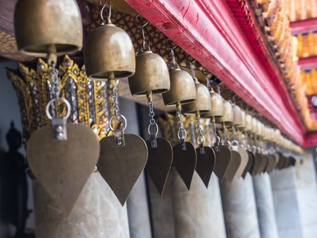 Small metal vintage bell with heart-shaped in Buddhist templeの写真素材