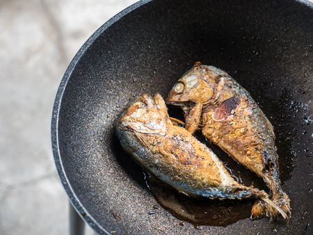 Fried mackerel fish on panの写真素材