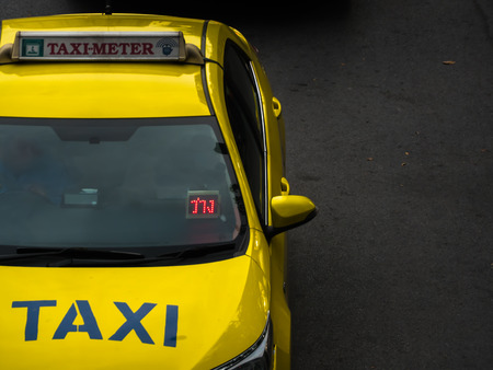 Vacant taxi meter car on road in Bangkok Thailandの写真素材