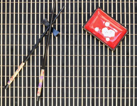 Bamboo mat, sushi sticks, sauce bowl, top viewの写真素材